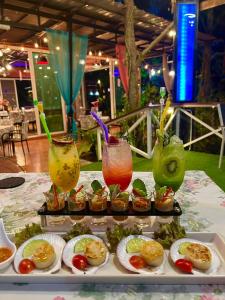 a table topped with plates of food and drinks at Nubdao Resort&Restaurant in Nong Prue +23 photos