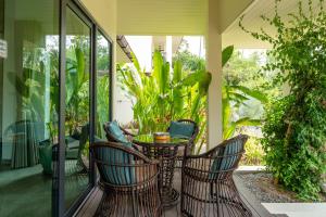 a porch with a table and two chairs on it at Palm Rose Villa in Hinkong