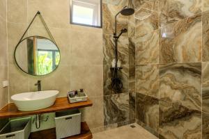 a bathroom with a sink and a mirror at Palm Rose Villa in Hinkong +14 photos