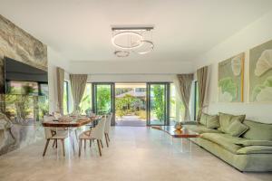 a living room with a green couch and a table at Palm Rose Villa in Hinkong