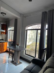 a living room with a table in front of a window at casa borde de lago4 in Panajachel