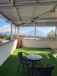 a patio with two chairs and a table on a roof at casa borde de lago4 in Panajachel