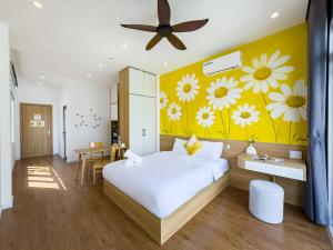 a bedroom with a bed with flowers on the wall at Louis Home in Danang