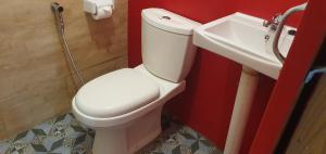 a bathroom with a white toilet and a sink at the bamboo Bali Cabin in Nusa Dua +40 photos
