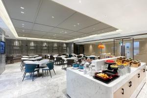a restaurant with tables and chairs and a buffet at Atour Hotel Hefei Yaohai Heping Road in Hefei