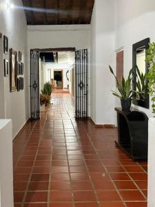 a hallway with a tile floor and wrought iron doors at Casa Mashala in Santa Cruz de Mompox