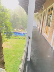 an empty porch of a house with a yard at Sigiri Yahana in Sigiriya