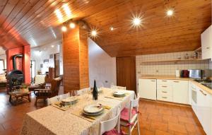 a kitchen with a table and a dining room at Awesome Apartment In Sovramonte With Wifi in Sovramonte