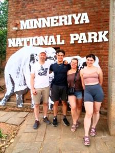 a group of people standing in front of a sign at Sigiri Yahana in Sigiriya