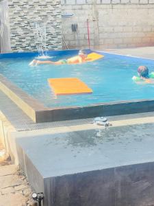 two children are swimming in a swimming pool at Sigiri Yahana in Sigiriya