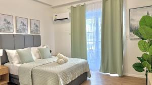 a bedroom with a bed with a teddy bear on it at Stylish Studio Unit near Airport w Pool and WiFi in Pusok +13 photos