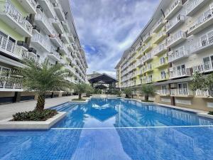 a large swimming pool in the middle of a building at Stylish Studio Unit near Airport w Pool and WiFi in Pusok
