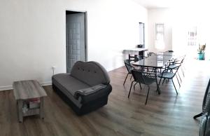a living room with a couch and a table and chairs at PNAF Farm resort in Pililla
