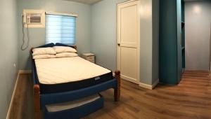 a small bedroom with a bed and a window at PNAF Farm resort in Pililla +44 photos