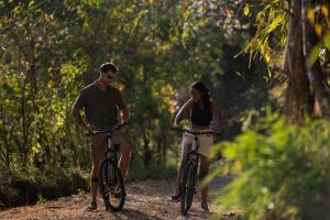 a man and a woman riding bikes on a trail at Visama Explorer Nan in Ban Huai Luk