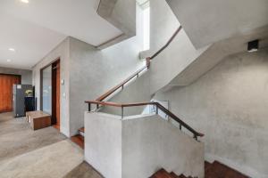 a concrete staircase in a home with a stair case at Urbanview Hotel The Lodge Karawaci in Tangerang