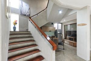 a staircase in a house with a vase of flowers at Urbanview Hotel The Lodge Karawaci in Tangerang