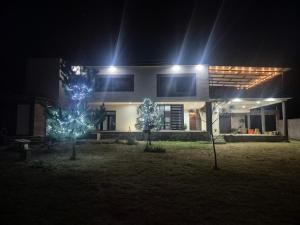 a house at night with two trees with lights at Finca Sierra Madre in Durango