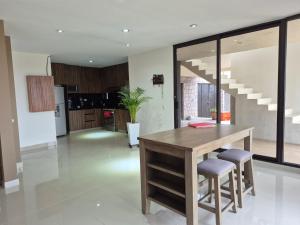 a kitchen and dining room with a wooden table and chairs at Finca Sierra Madre in Durango