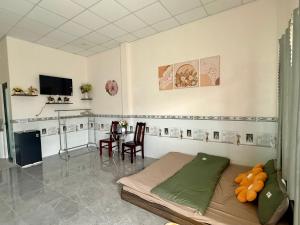 a living room with a bed and a table at Thùy Vinh Homestay in Phú Quốc