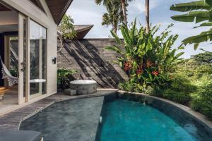 a swimming pool in the backyard of a villa at Astera Resort & Spa Canggu by Ini Vie Hospitality in Canggu