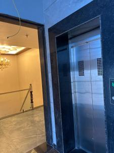 a elevator in a building with a glass door at Royal kesari in Jhunjhunūn