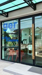 a store window with a table and chairs in it at Patra Phuket Private Residence in Ban Nong Chaeng