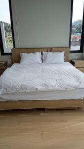 a bed with white sheets and pillows in a bedroom at Patra Phuket Private Residence in Ban Nong Chaeng +13 photos