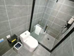 a bathroom with a white toilet and a shower at 拾贰小院 in Zhongyantou