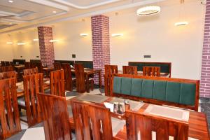 a dining room with wooden tables and chairs at Hotel The Sabhyansh in Khātu