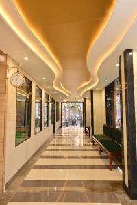 a hallway of a building with a clock on the ceiling at Hotel The Sabhyansh in Khātu