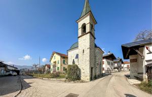 an old stone church with a steeple on a street at Awesome Apartment In Sovramonte With Wifi in Sovramonte