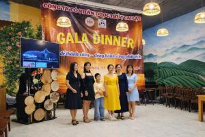 a group of women standing in front of a banner at Tomato Villa & Restaurant in Da Lat