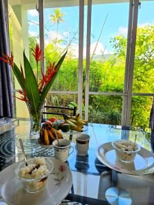 a glass table with two plates of food on it at mountain retreat villa in Kandy