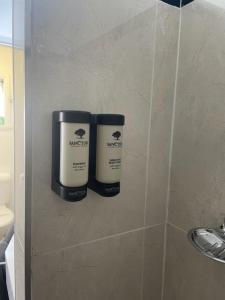 two rolls ofodorizers on a wall in a bathroom at Taree Lodge Motel in Taree +19 photos