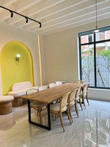 a dining room with a wooden table and chairs at Biệt thự Hồ Tràm B SH42 in Xuyên Mộc