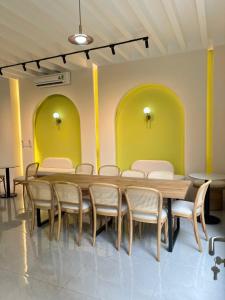 a table and chairs in a room with yellow walls at Biệt thự Hồ Tràm B SH42 in Xuyên Mộc +33 photos