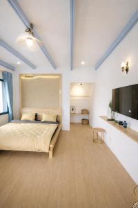 a bedroom with a bed and a flat screen tv at Tomato Villa & Restaurant in Da Lat +28 photos