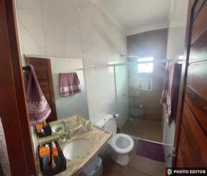 a bathroom with a sink and a toilet at Casa Cristã Familiar JR in Paracuru +19 photos