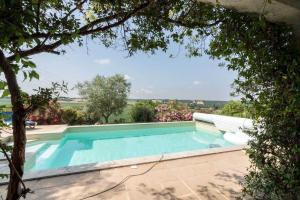 a swimming pool in a house with a tree at La marquette in Montrabé +12 photos