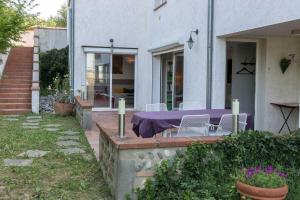 a house with a purple table and chairs on a patio at La marquette in Montrabé
