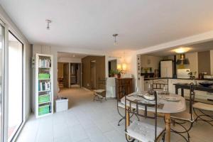 a kitchen and living room with a table and chairs at La marquette in Montrabé
