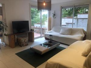 a living room with a couch and a tv at La marquette in Montrabé