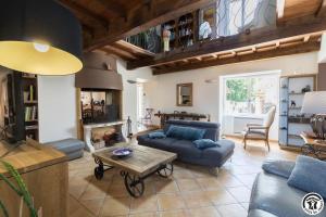 a living room with a couch and a table at La ferme in Ponlat-Taillebourg