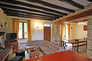 a living room with a couch and a table at Le monteil in Arnac-la-Poste