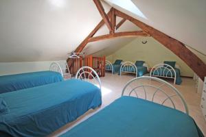 a room with two beds and chairs in a attic at Le monteil in Arnac-la-Poste +27 photos