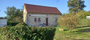 a small stone house with a red roof at La rivaille in Lussac-les-Églises