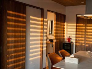 a dining room with a table and orange chairs at Sankando Villa Hotel in Fujikawaguchiko +65 photos