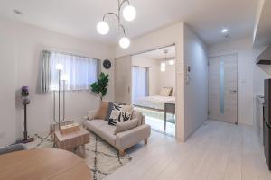 a living room with a couch and a bedroom at New Open! SunLight 岸里 in Osaka