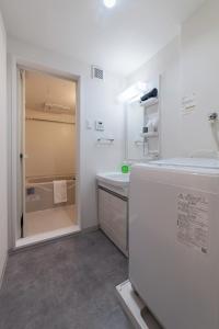 a white bathroom with a sink and a refrigerator at New Open! SunLight 岸里 in Osaka +84 photos